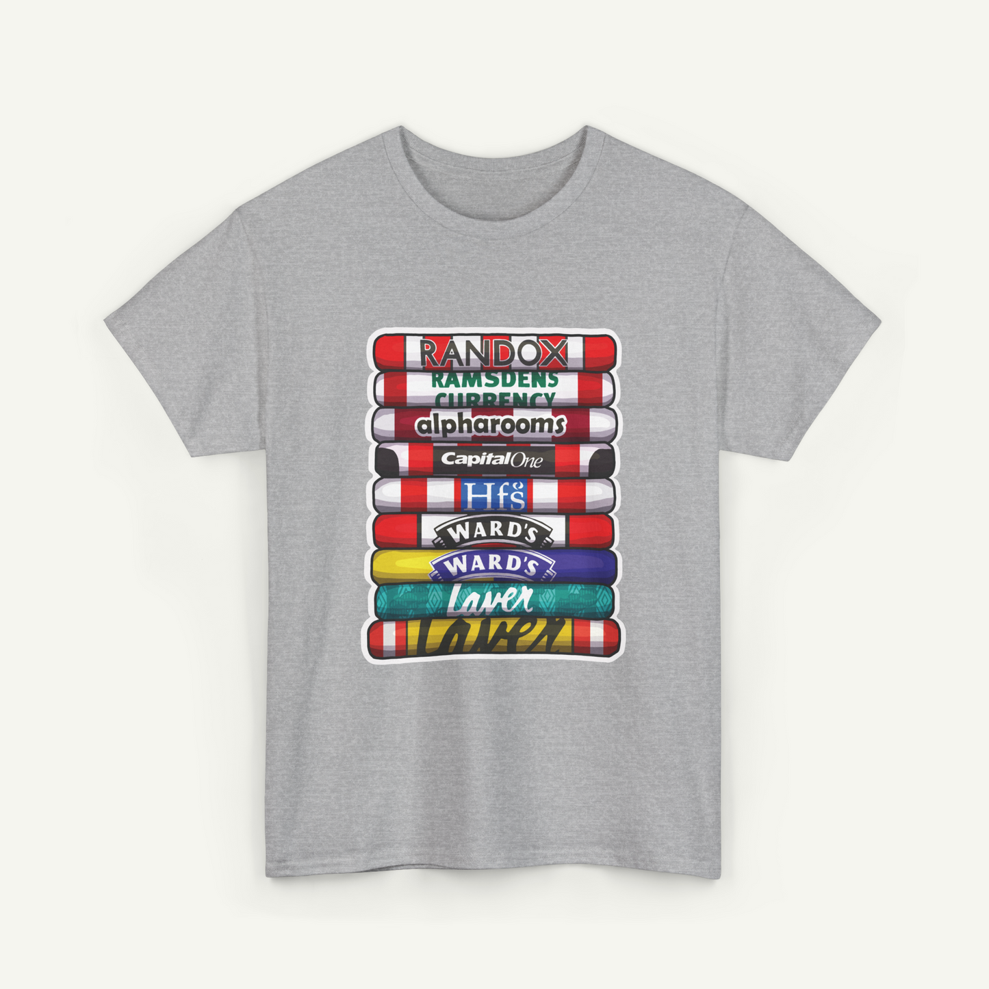 A gray t-shirt with a graphic design featuring a stack of colorful books or book-like objects, each with a different logo or text on them.