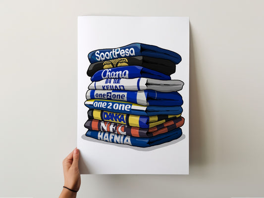 A hand is holding a poster with a stack of colorful shirts, each with a different text label.