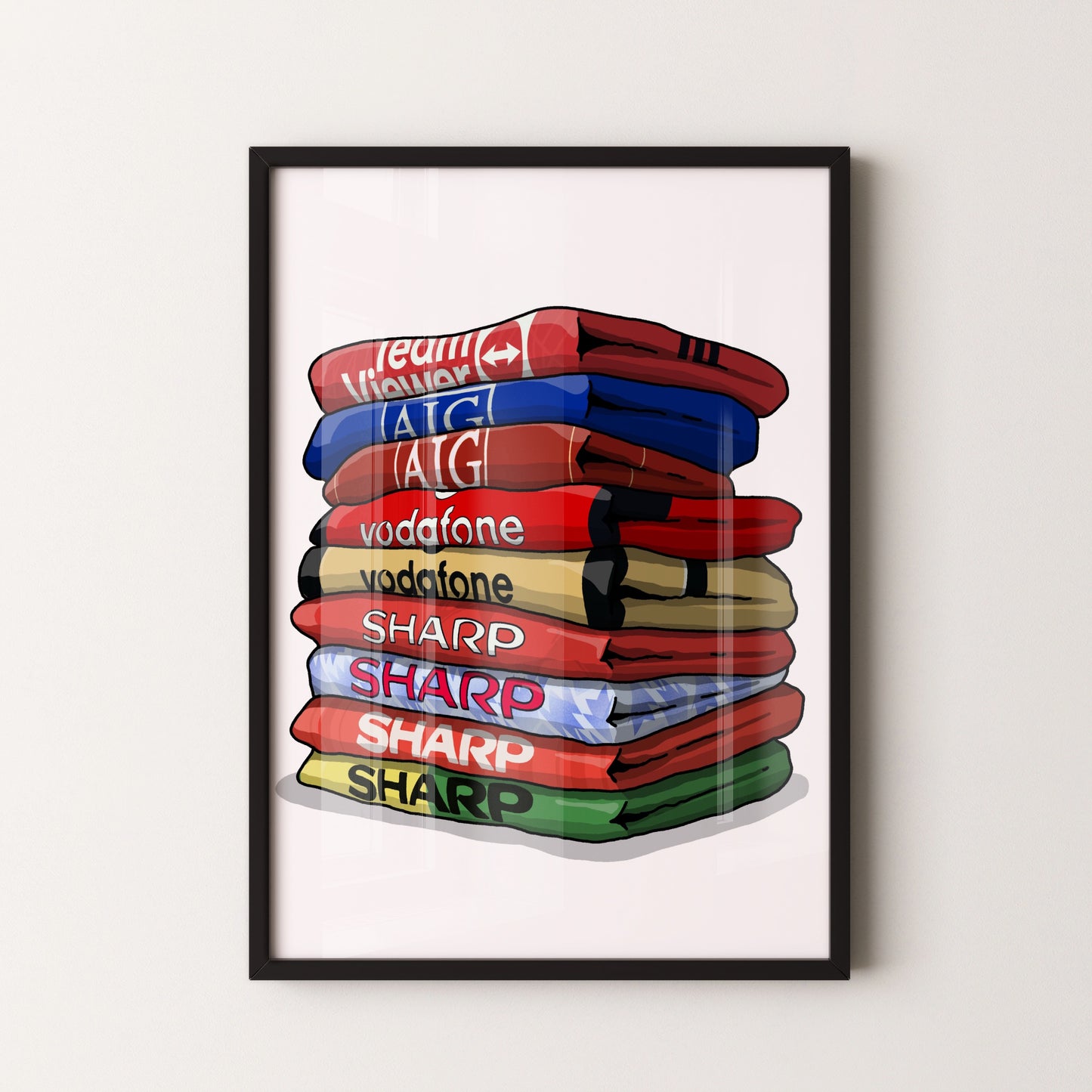 A framed illustration of a stack of colorful towels with various text on them, including "Team Vodafone", "vodafone", "SHARP", "SHARP", and "SHARP".