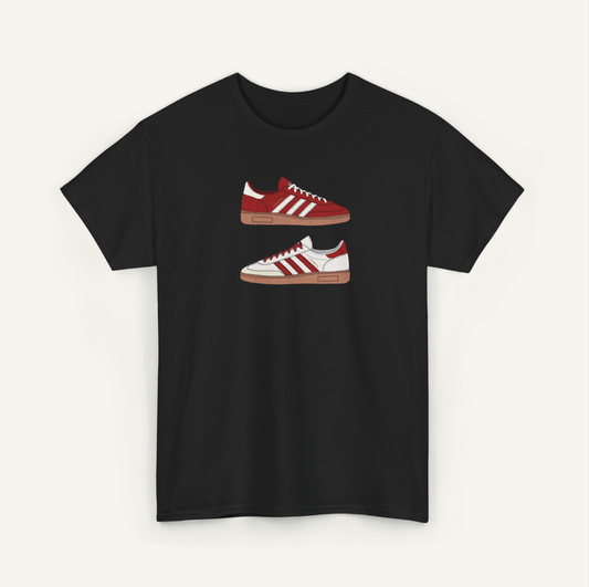 A black t-shirt with a graphic design of two red and white Adidas sneakers printed on it.