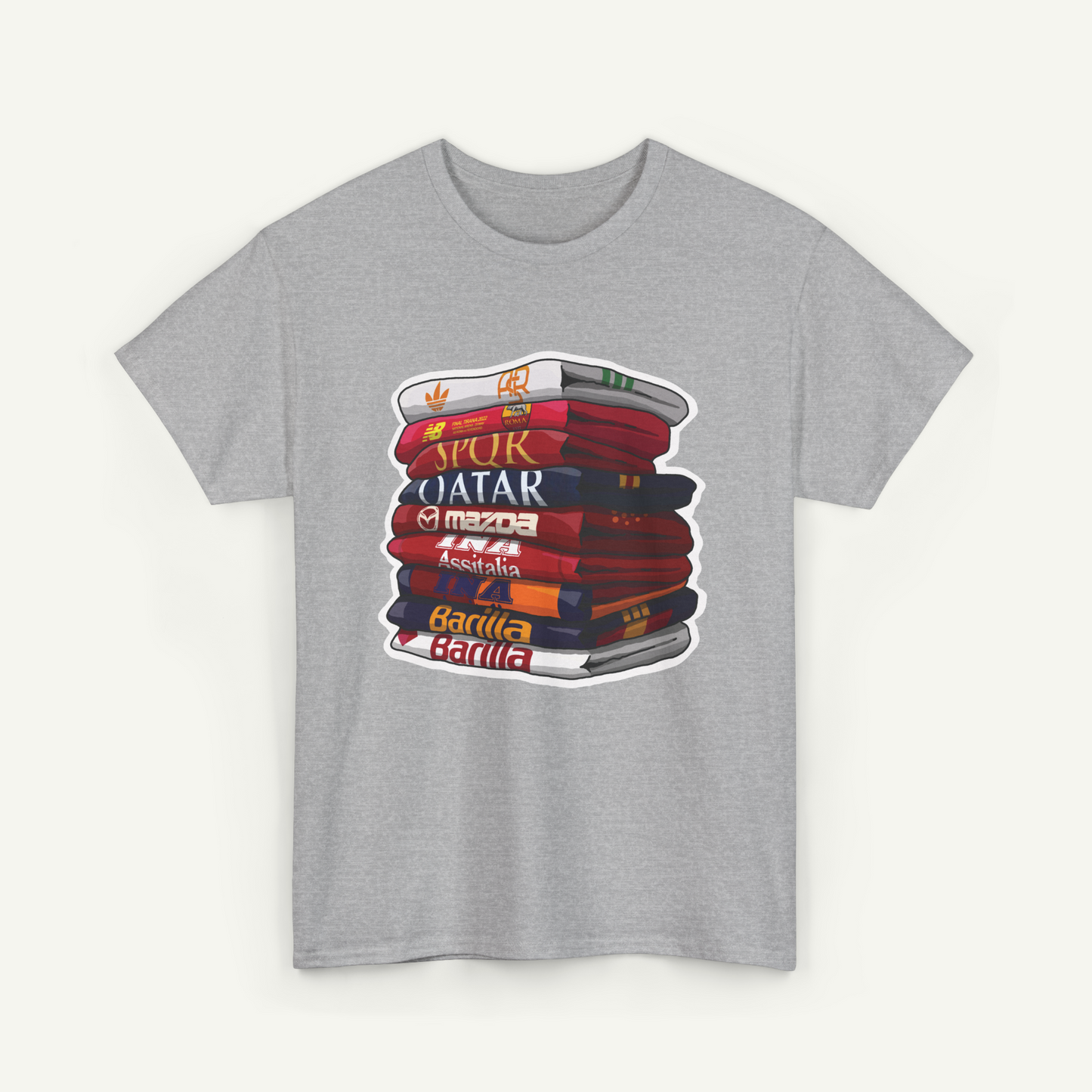A gray t-shirt with a graphic design depicting a stack of colorful books with the text "Qatar" written on them.