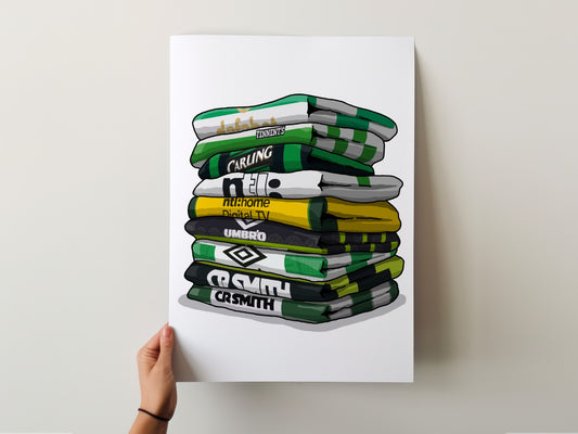 A hand is holding up a poster with a stack of various sports team towels, each with different logos and text.