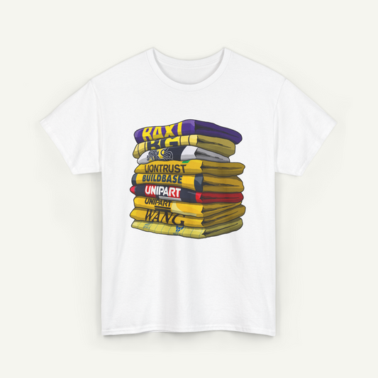 A white t-shirt with a graphic design depicting a stack of colorful books or books with various text on them.