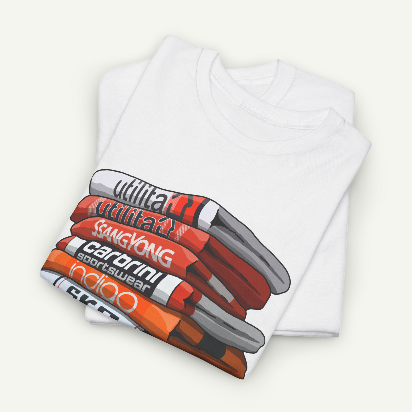 A white t-shirt with a graphic design depicting a stack of various colored objects, including orange, red, and white.