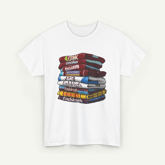 A white t-shirt with a stack of colorful books arranged in a pile.