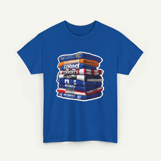 A blue t-shirt with a graphic design depicting a stack of books or books, with various text elements such as "32 Red", "Cricket", "Meewans", and "Meewans" printed on the books.