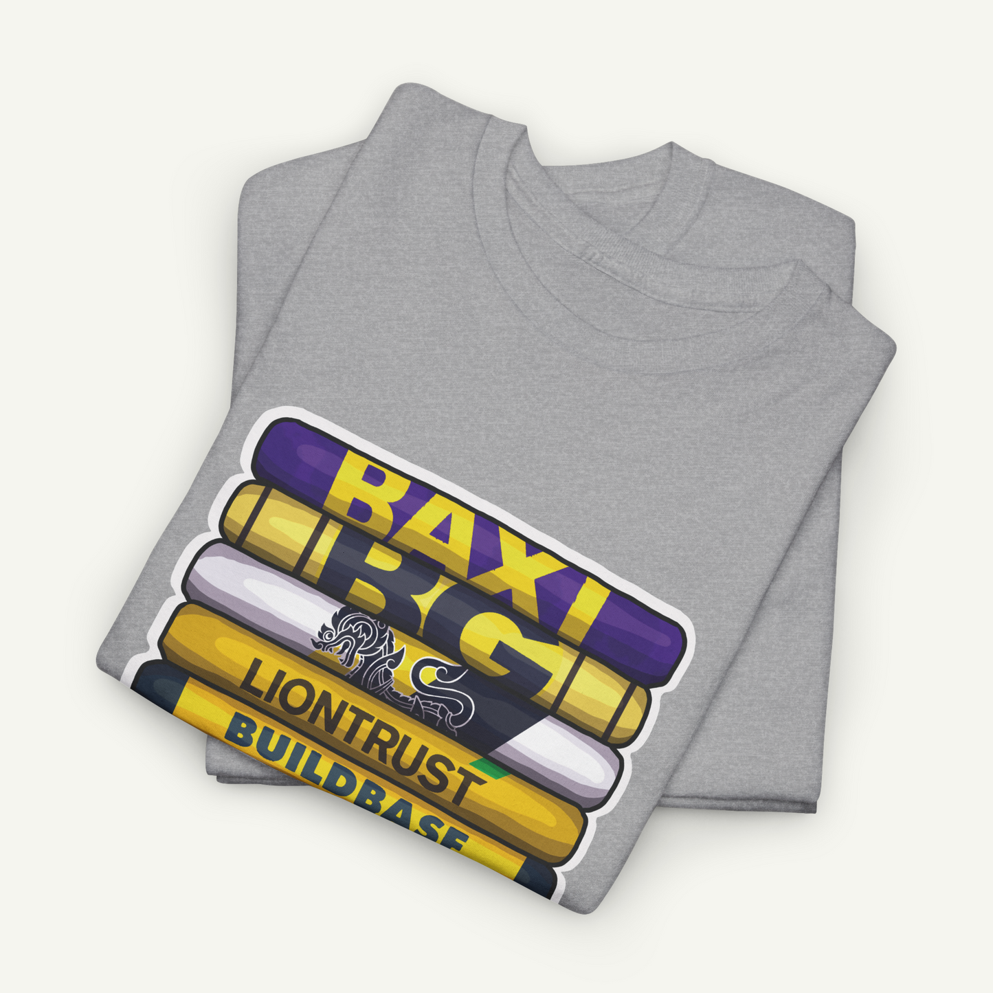 A gray t-shirt with a graphic design featuring a stack of crayons with the text "BAXI" and "LIONTRUST BUILDBASE" printed on them.