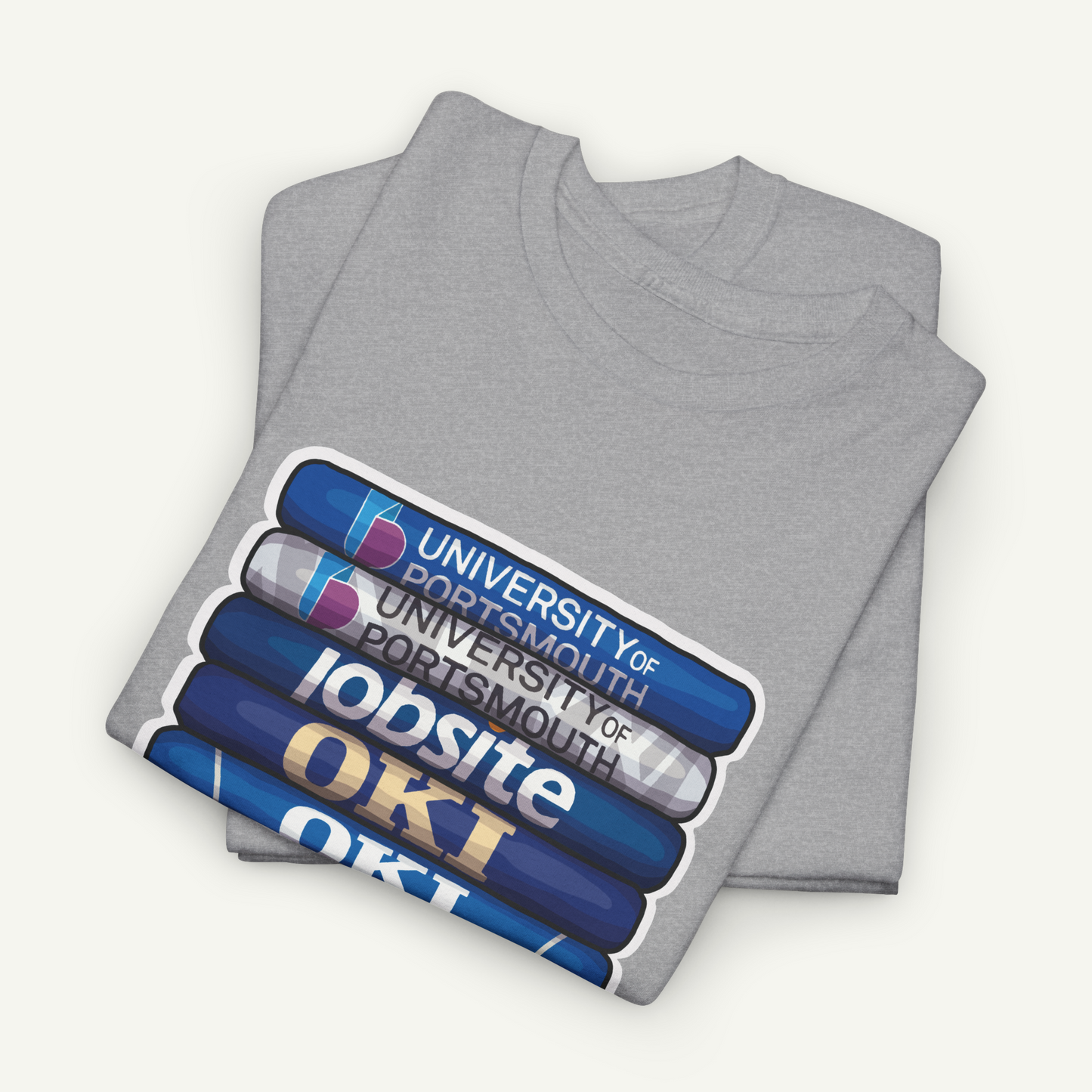 A gray t-shirt with a graphic design featuring a stack of blue and white books with the text "OKI" printed on them.