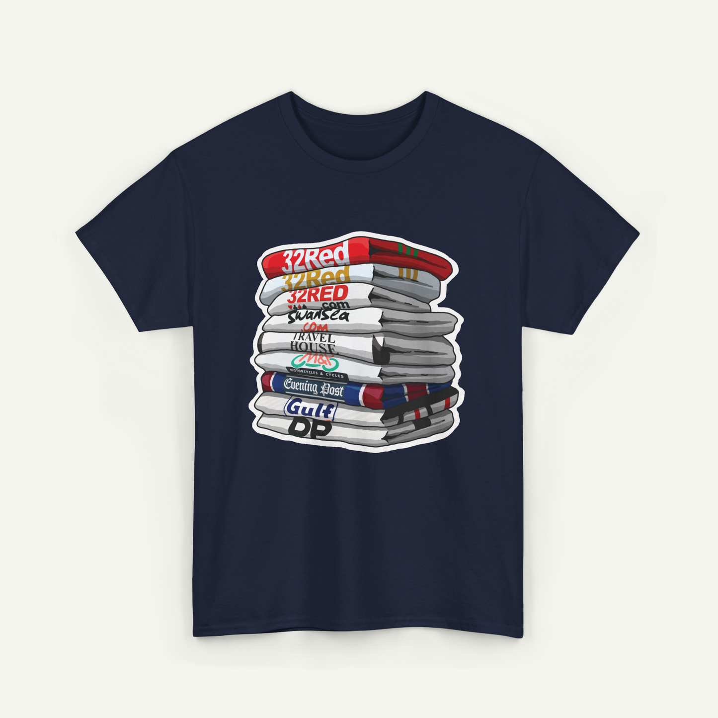 A navy blue t-shirt with a graphic design depicting a stack of books or magazines with various text labels on the spines.
