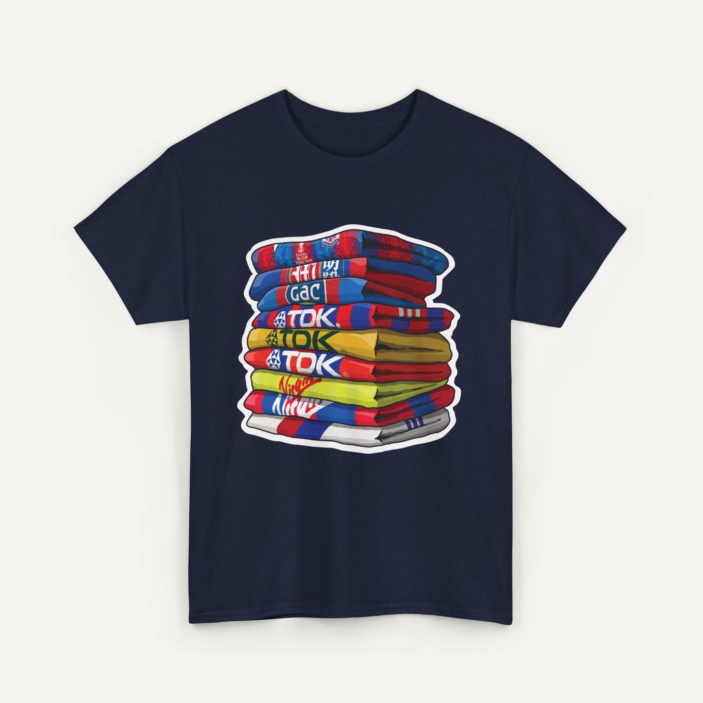 A navy blue t-shirt with a graphic design depicting a stack of colorful towels with the text "TOK" printed on them.