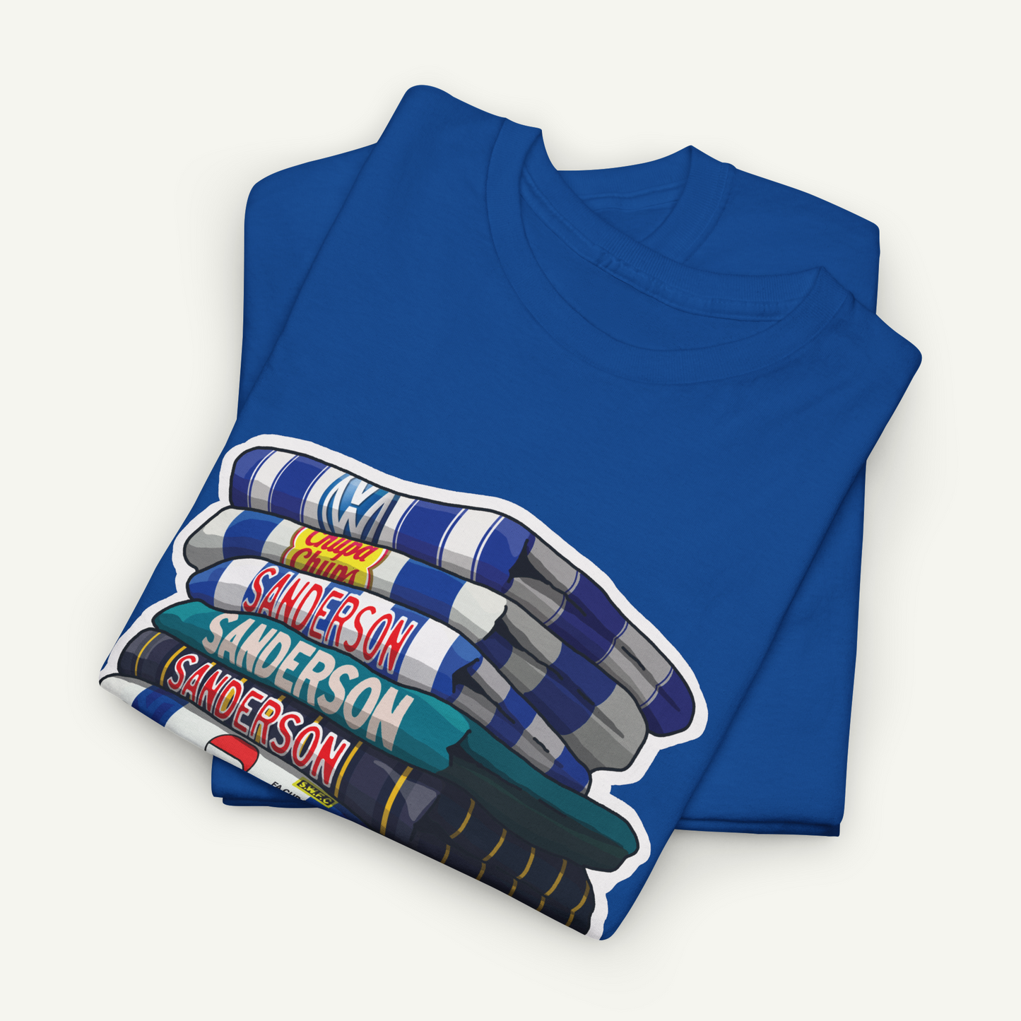 A blue t-shirt with a graphic design depicting a stack of books with the name 'Sanderson' printed on them.