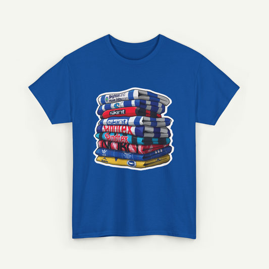 A blue t-shirt with a graphic design depicting a stack of colorful books or magazines.