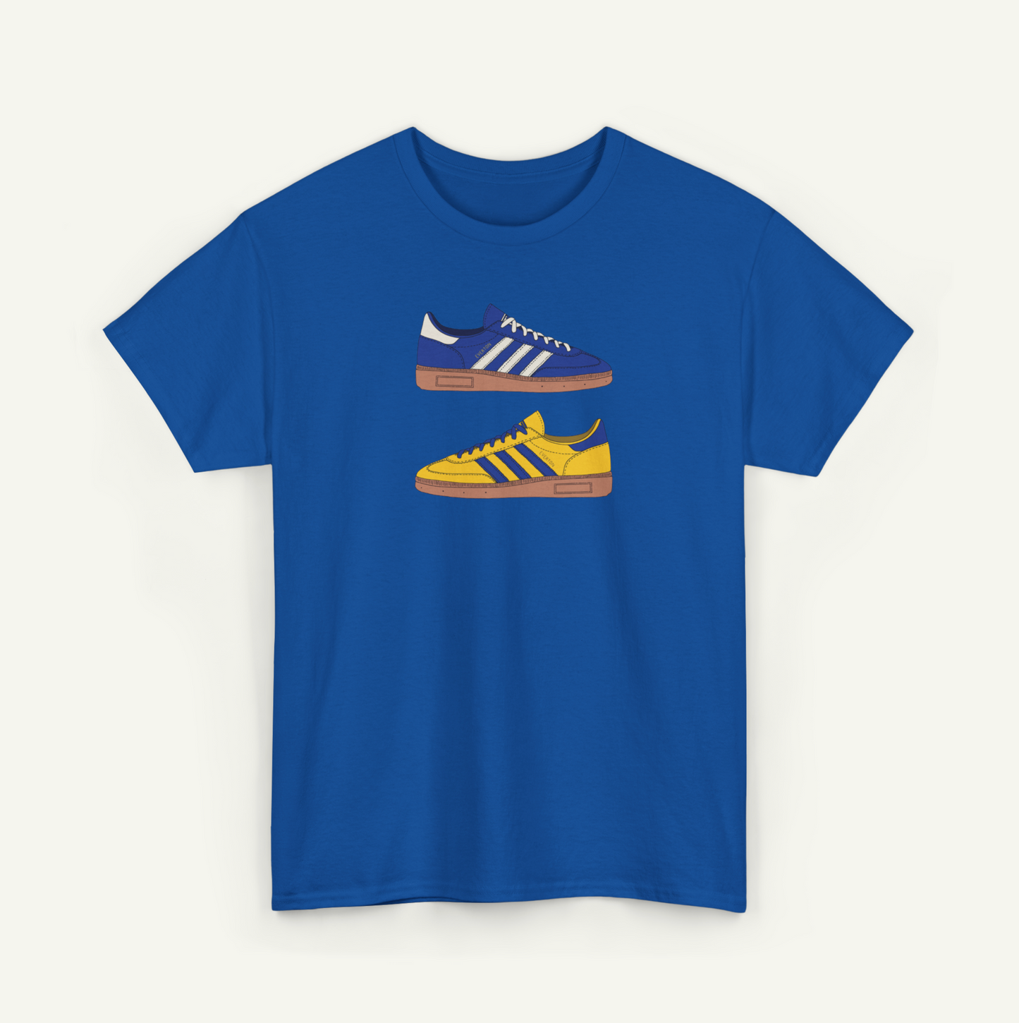 A blue t-shirt with a graphic design of two Adidas sneakers in different colors - blue and yellow.