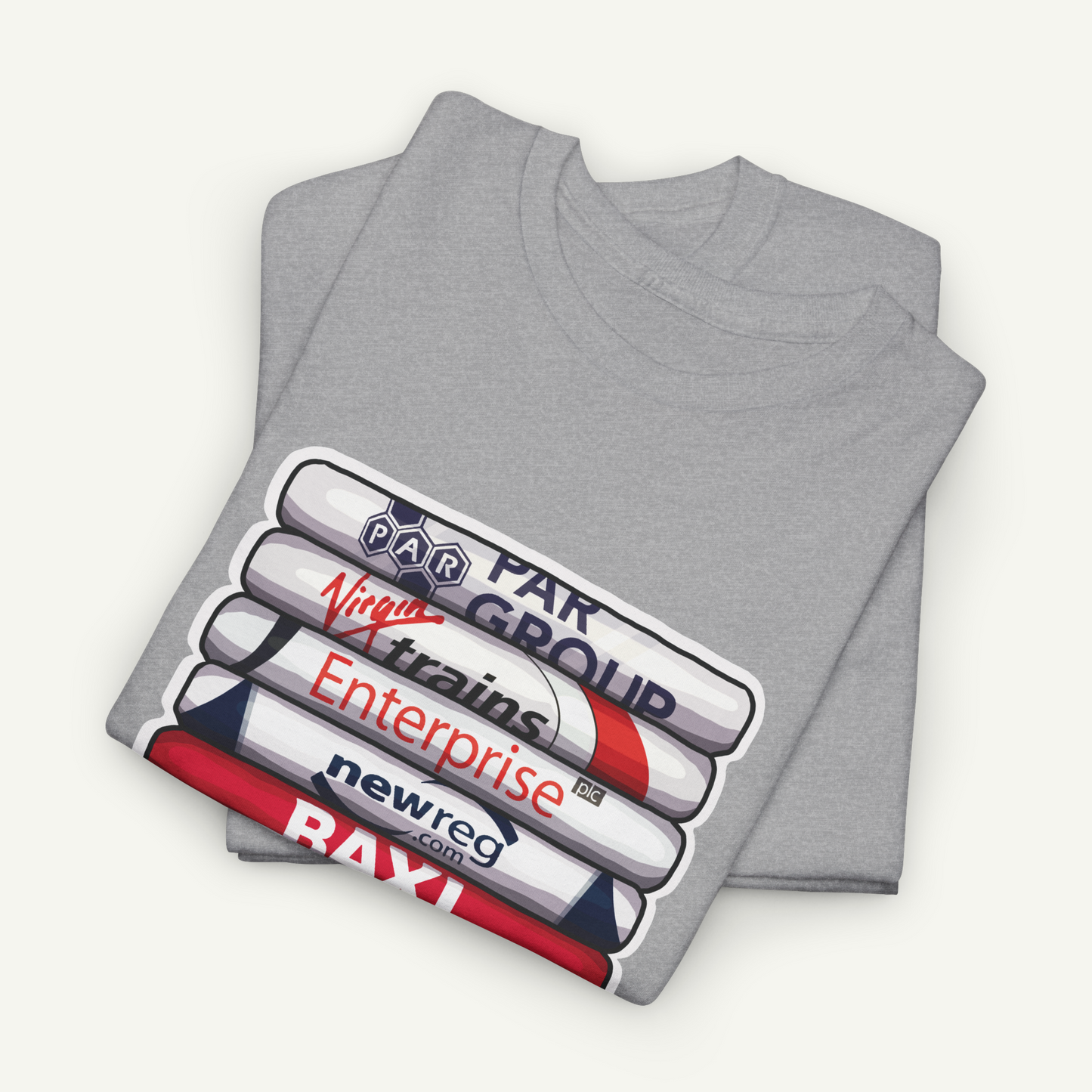 A gray t-shirt with a graphic design featuring a stack of books or cylinders with various text and logos printed on them.