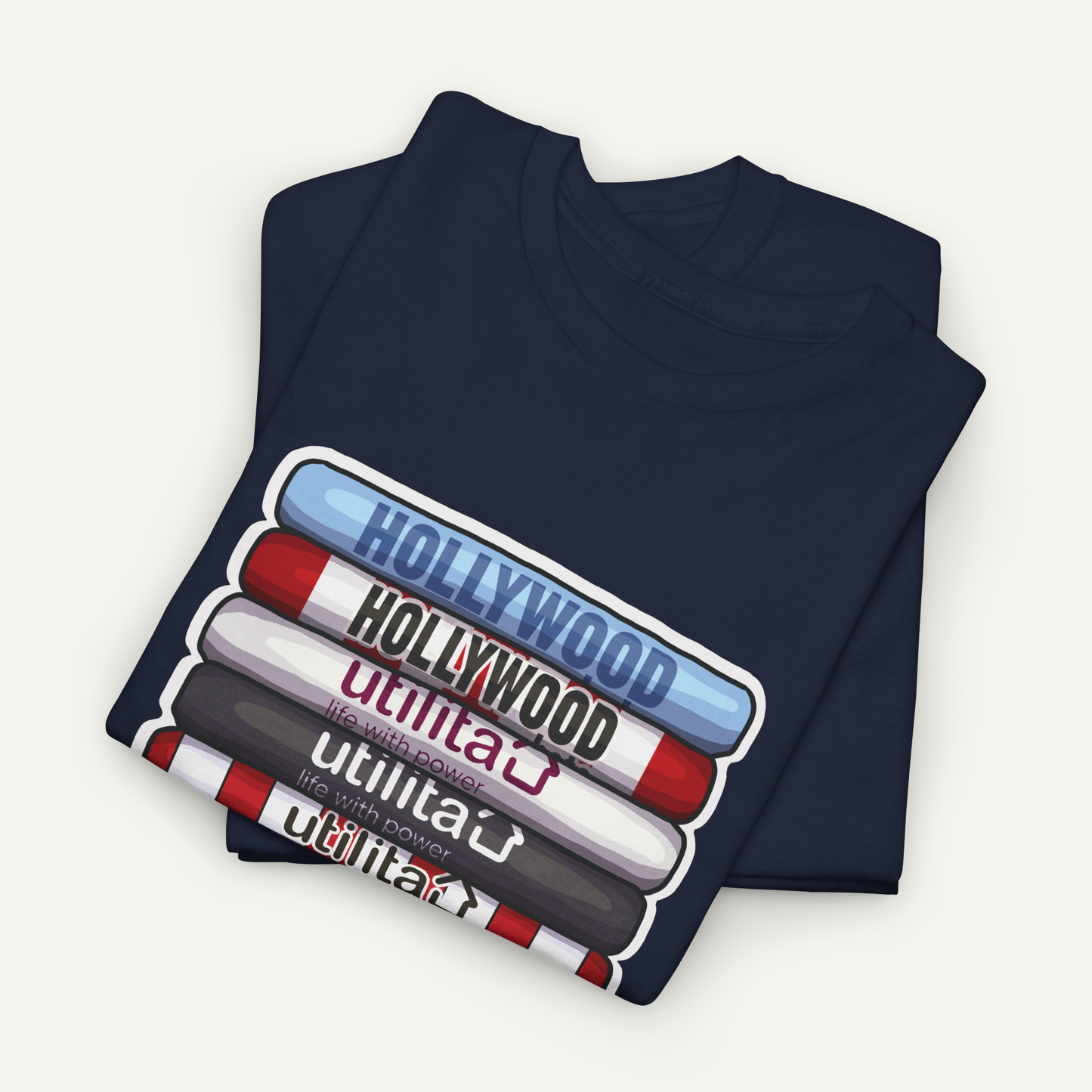 A navy blue t-shirt with a graphic design depicting the words "Hollywood" in various colors and styles, suggesting a collection of iconic Hollywood landmarks.