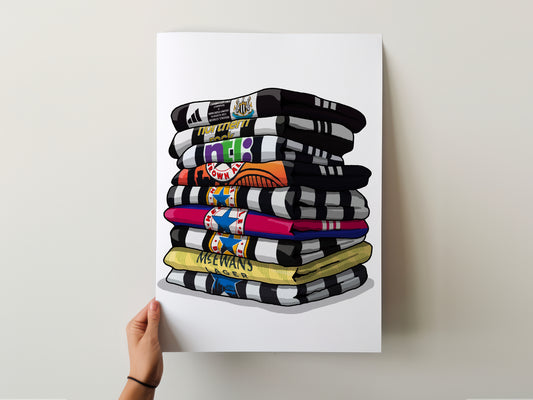 A hand is holding up a poster with a stack of colorful towels or blankets, each with different patterns and designs.
