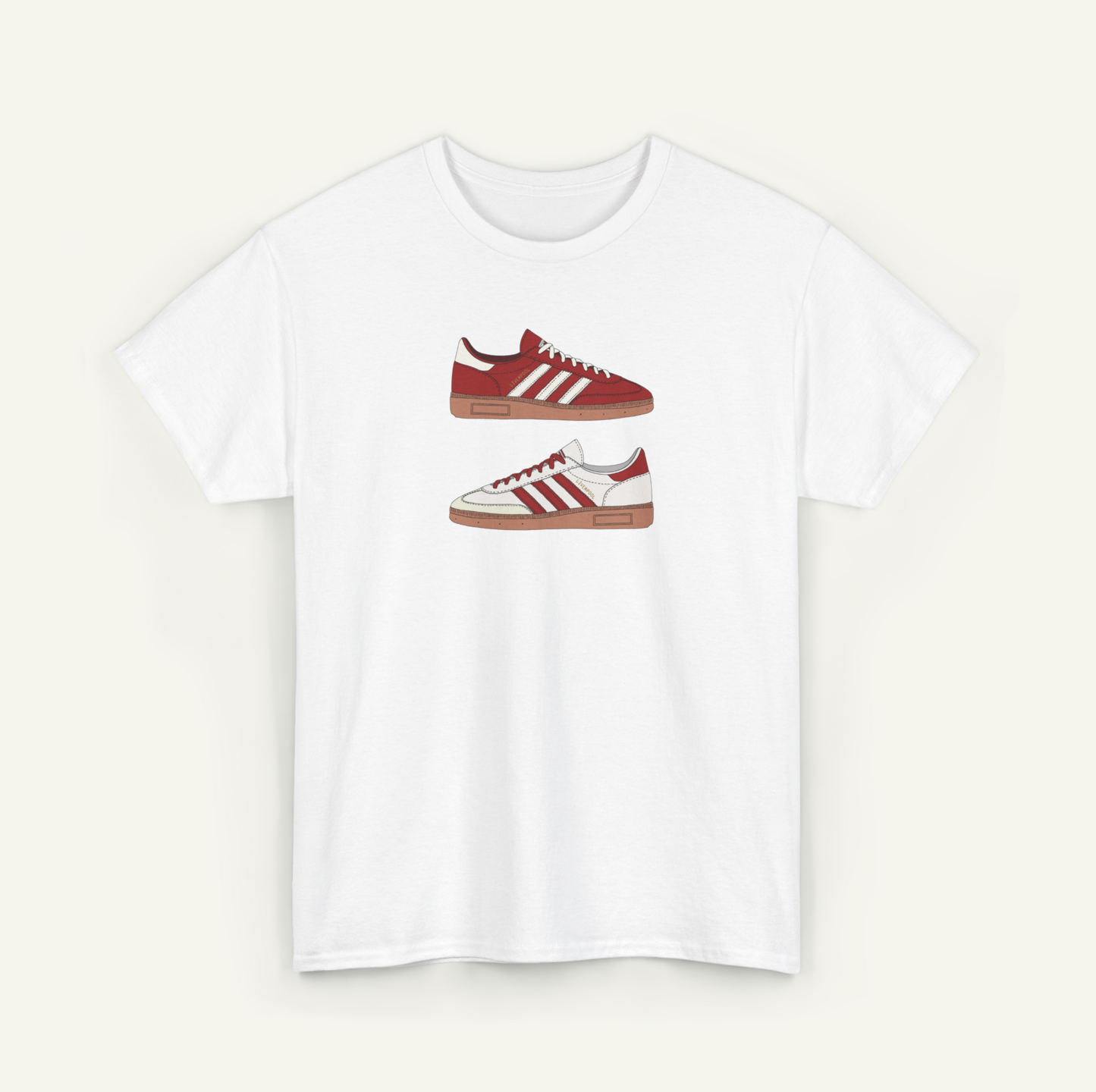 A white t-shirt with a graphic design of two red and white Adidas sneakers.