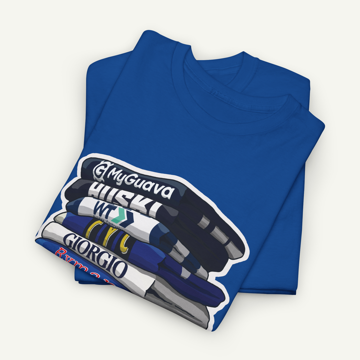 A blue t-shirt with a graphic design depicting a stack of books or magazines with the titles "My Guava", "Huskies", "W.T.G.I.R.G.I.O", and "Giorgio".