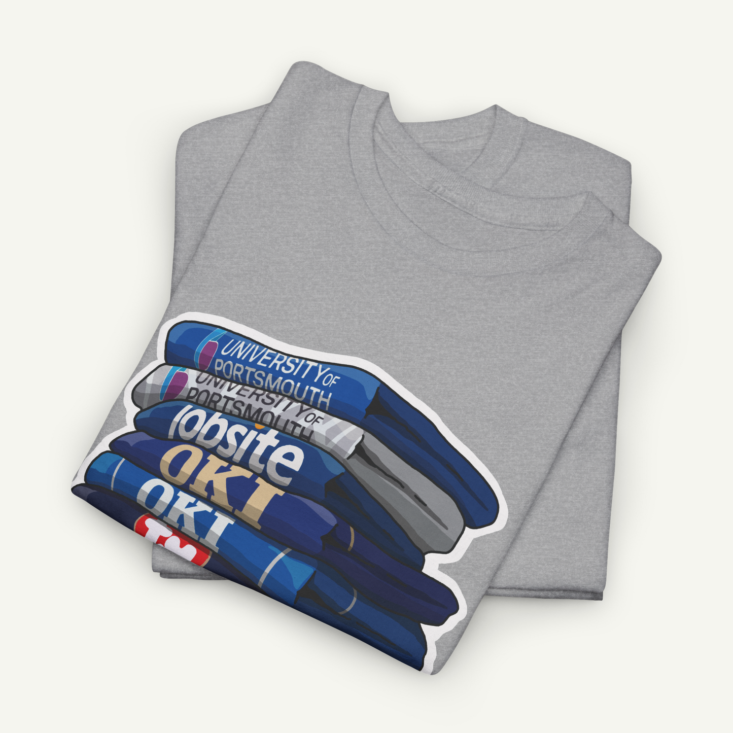 A gray t-shirt with a graphic design depicting a stack of books, with the text "University of Portsmouth for Portsmouth" printed on the books.