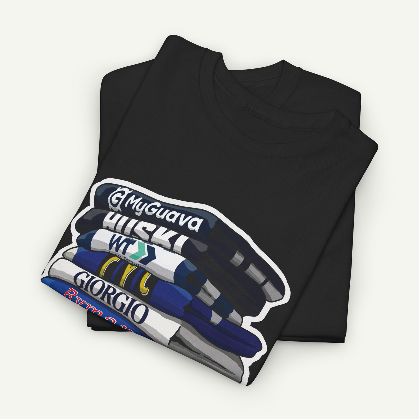 A black t-shirt with a graphic design depicting a stack of books or magazines with the titles "My Guava", "Huskies", "W.T.C.G.I.R.O", and "Giorgio".