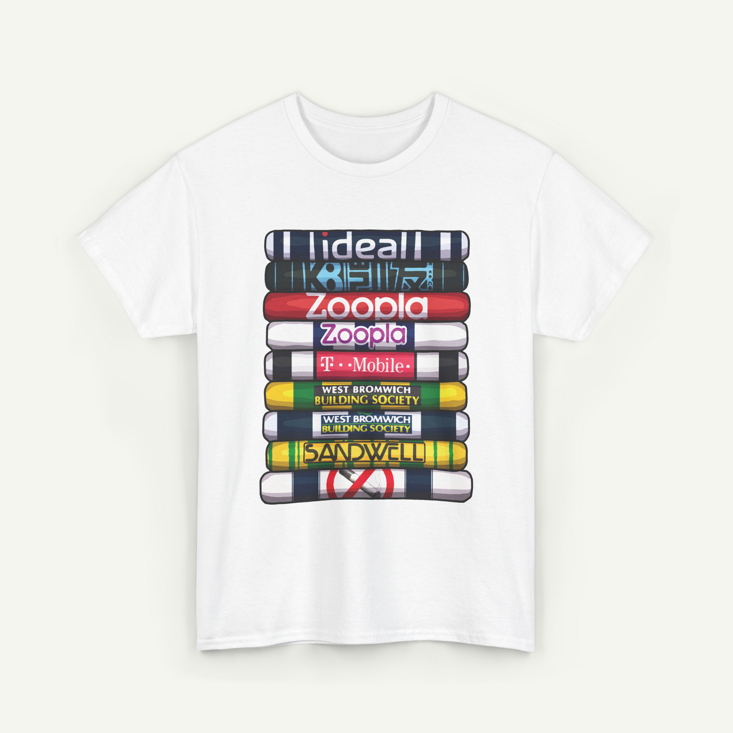 A white t-shirt with a graphic design depicting a stack of colorful books or magazines with various text labels on the spines.