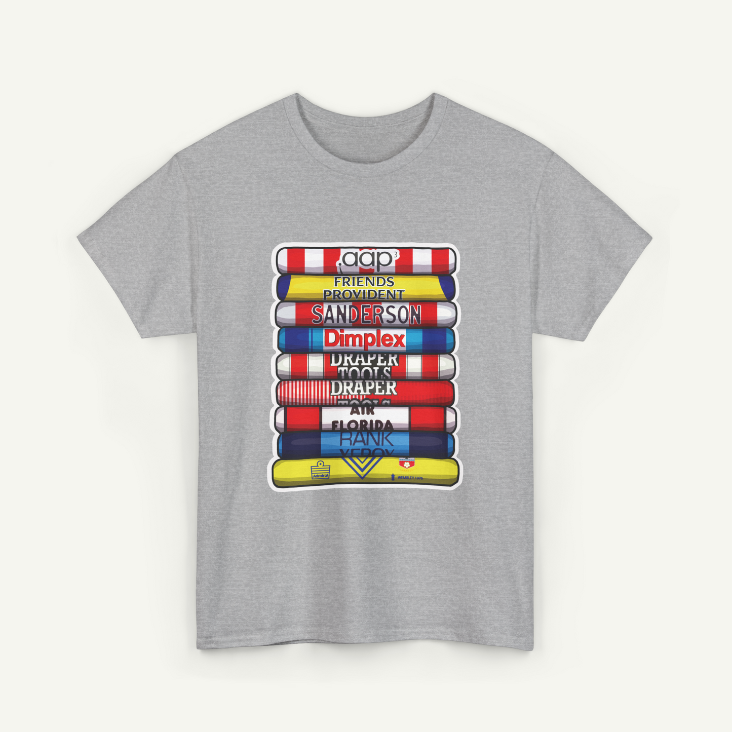A gray t-shirt with a graphic design depicting a stack of colorful books or magazines with various text titles on the spines.