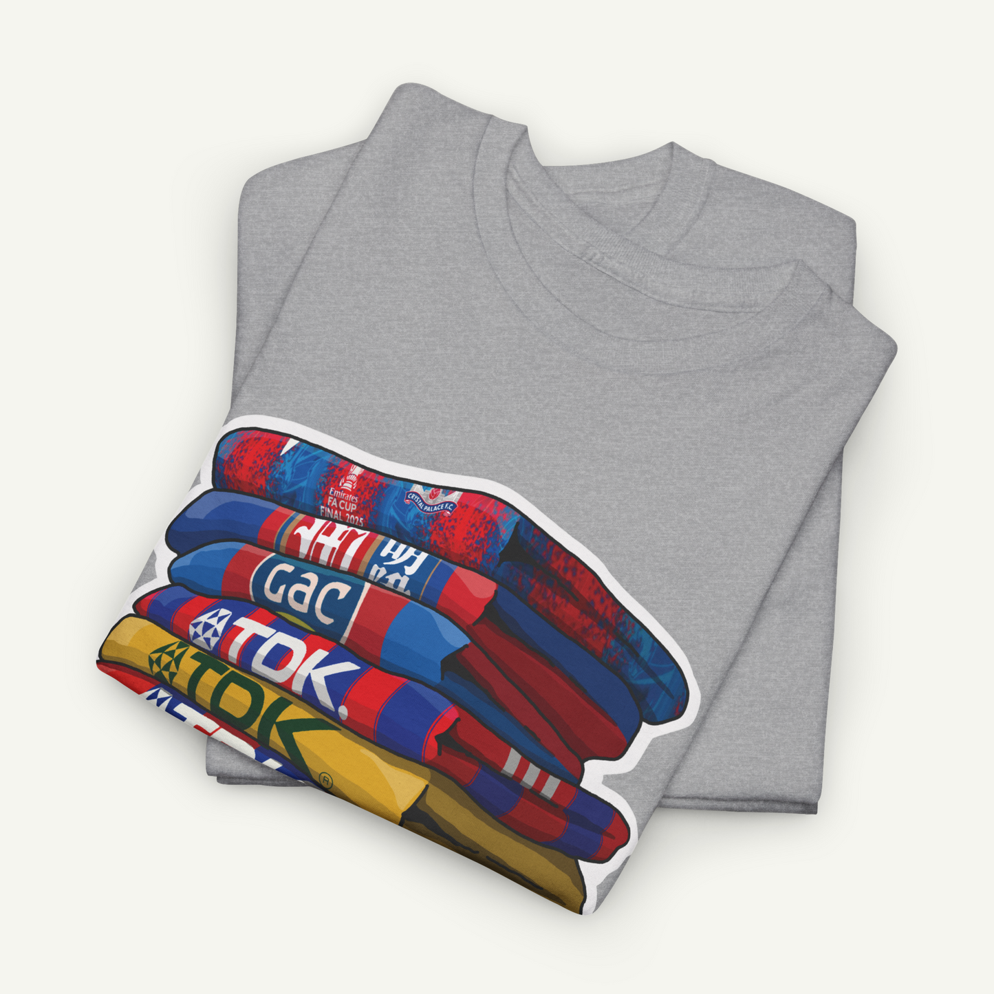 A gray t-shirt with a colorful graphic design depicting a stack of books or magazines.