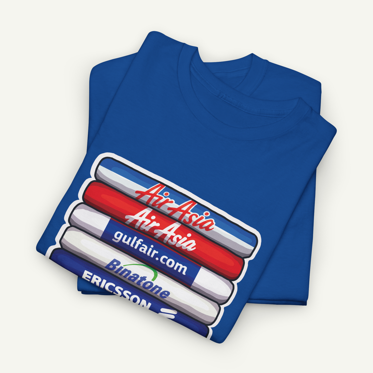 A blue t-shirt with a graphic design featuring a stack of three markers in red, white, and blue colors, along with the text "Air Asia" and "gulfair.com" printed on it.