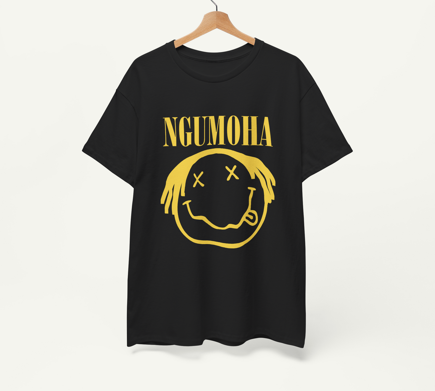 A black t-shirt with a yellow smiley face graphic and the text "NGUMOHA" printed on it.