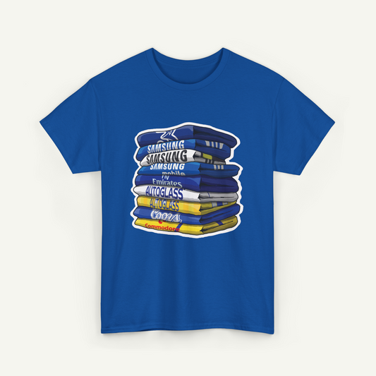 A blue t-shirt with a graphic design depicting a stack of books or magazines with the text "Samsung Autoglass Cooza" printed on them.