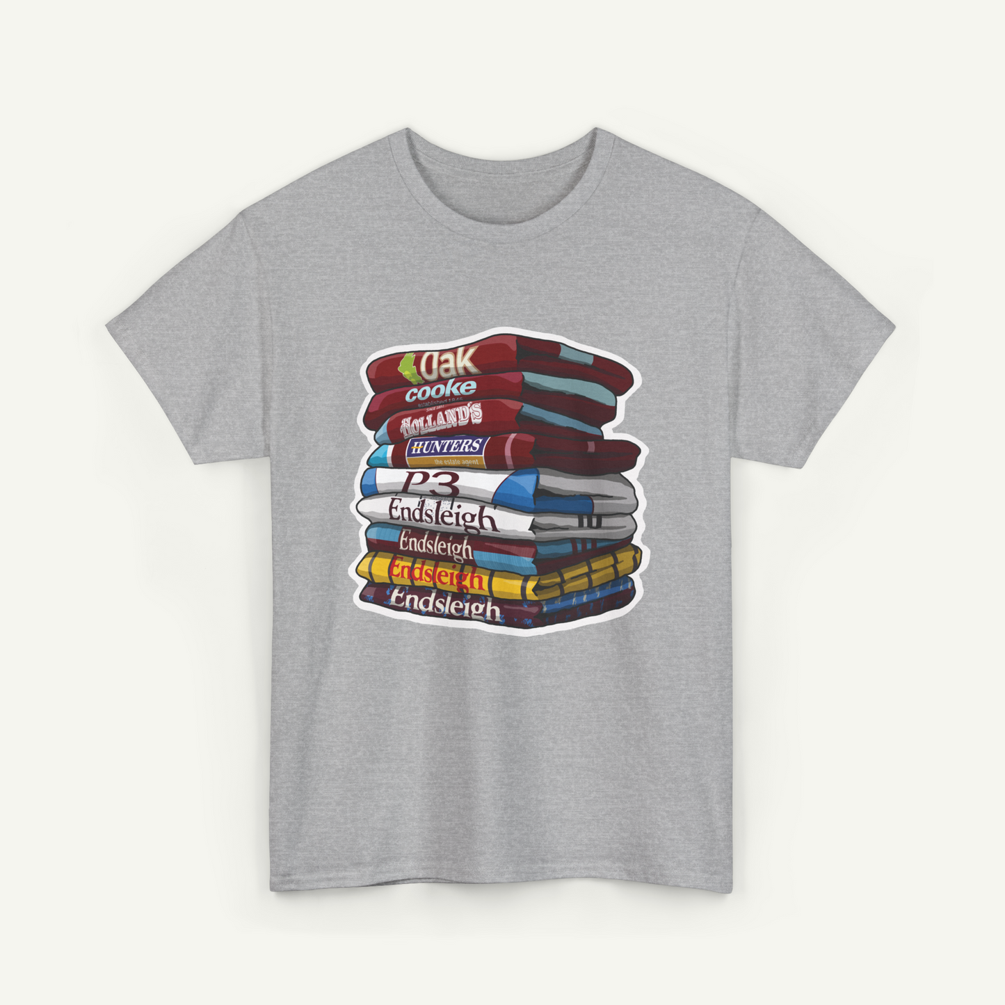 A gray t-shirt with a graphic design depicting a stack of colorful books.