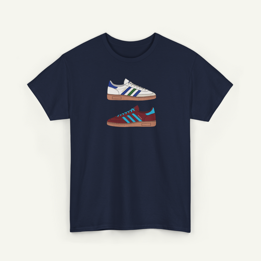 A navy blue t-shirt with a graphic design of two different colored Adidas sneakers.