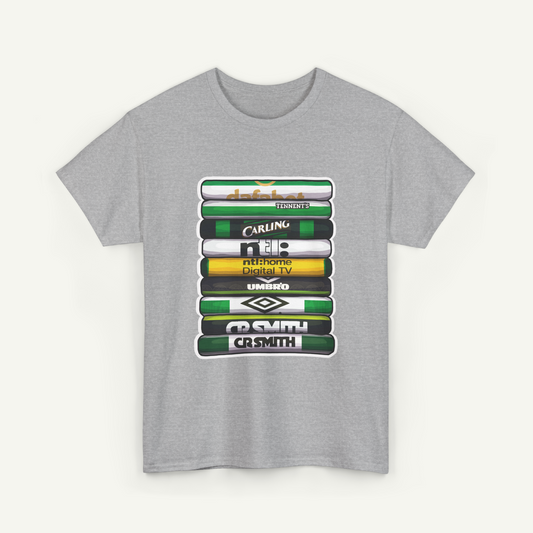 A gray t-shirt with a graphic design featuring a stack of colorful books or magazines with various text and logos printed on them.