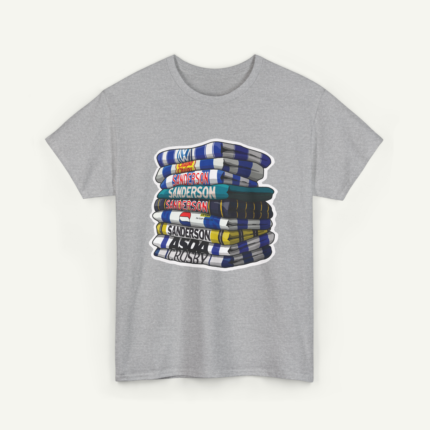 A gray t-shirt with a graphic design depicting a stack of colorful books or magazines.