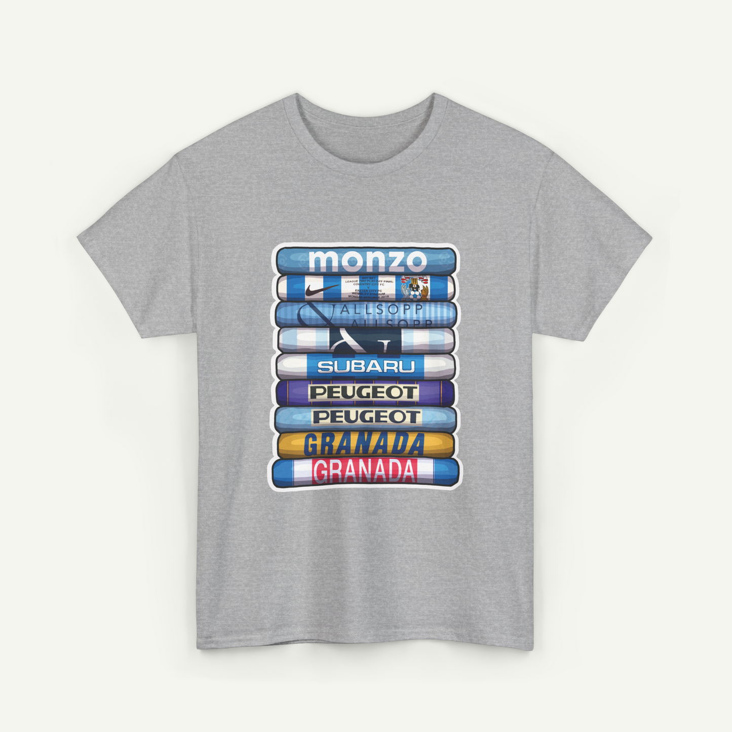 A gray t-shirt with a graphic design featuring a stack of colorful books or magazines with the titles of various car brands printed on them.