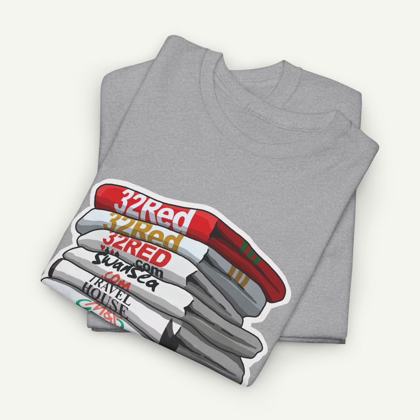 A gray t-shirt with a graphic design depicting a stack of books or magazines with the text "32Red" and "32Red" repeated on each book.