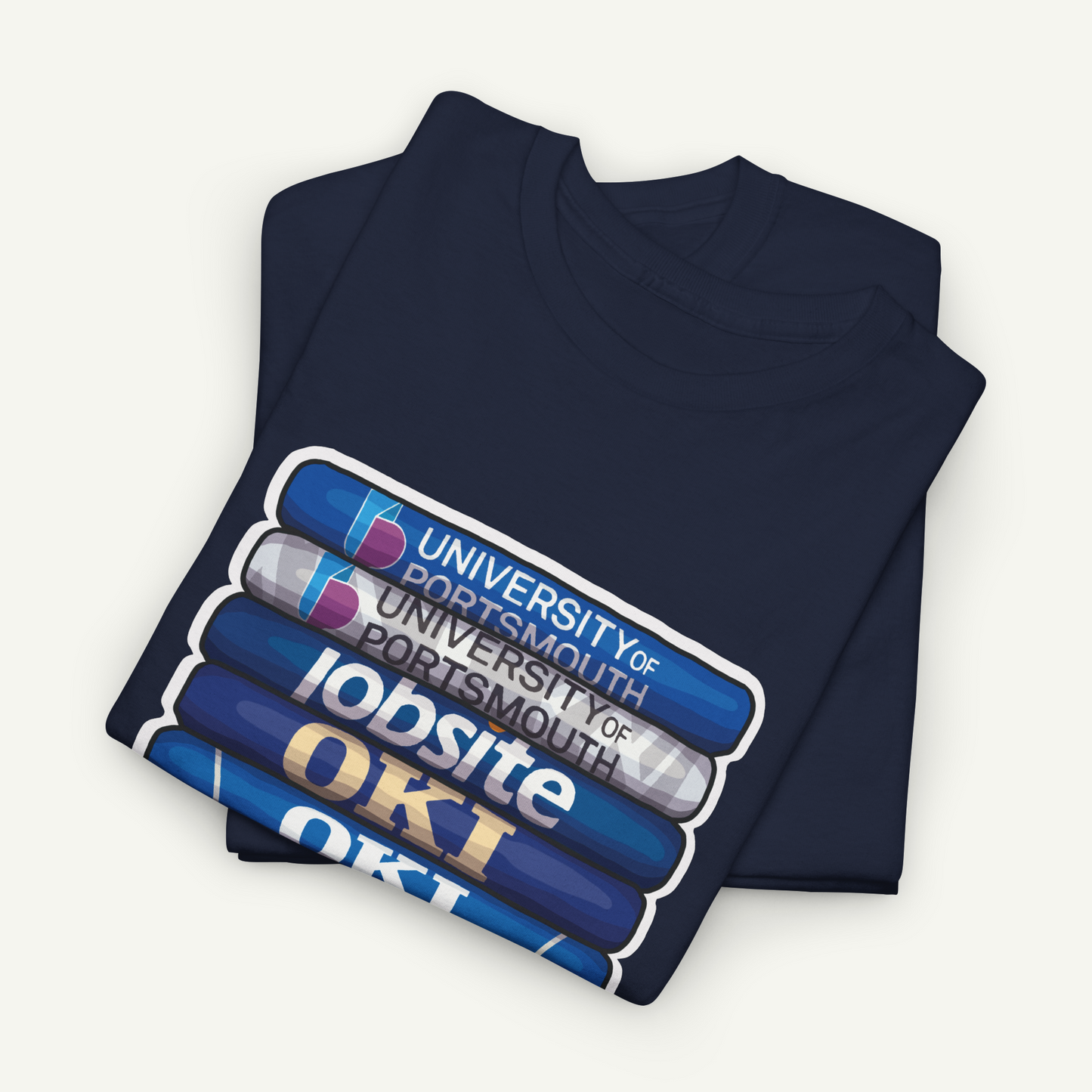 A navy blue t-shirt with a graphic design featuring a stack of books and the text "OKI" printed on it.