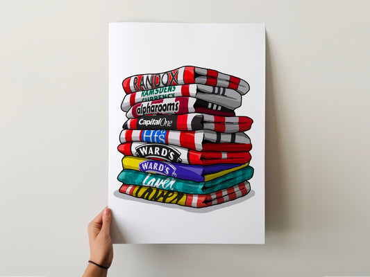 A hand is holding a poster with a stack of colorful towels, each displaying a different brand logo.