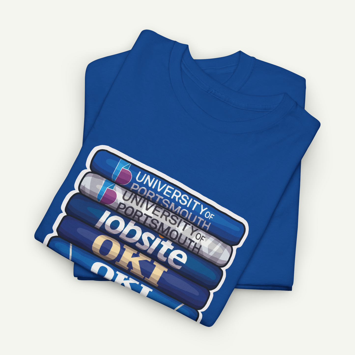 A blue t-shirt with a graphic design featuring a stack of books and the text "OKI" printed on it.