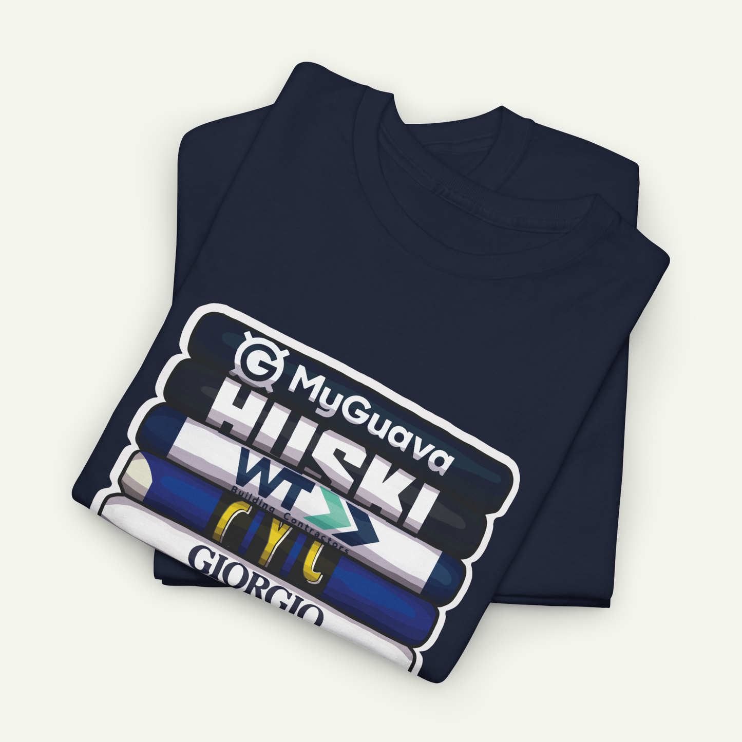 A navy blue t-shirt with a graphic design featuring a stack of books with various text and logos on the covers.