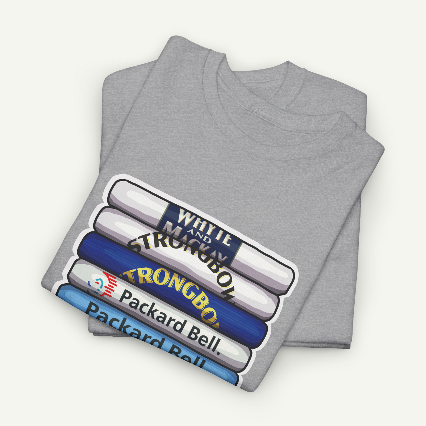 A gray t-shirt with a graphic design depicting a stack of books or magazines with the titles "WHITE AND STRONG BOW" and "PACKARD BELL" printed on them.