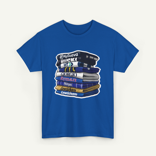 A blue t-shirt with a graphic design depicting a stack of books with various text labels on the spines.