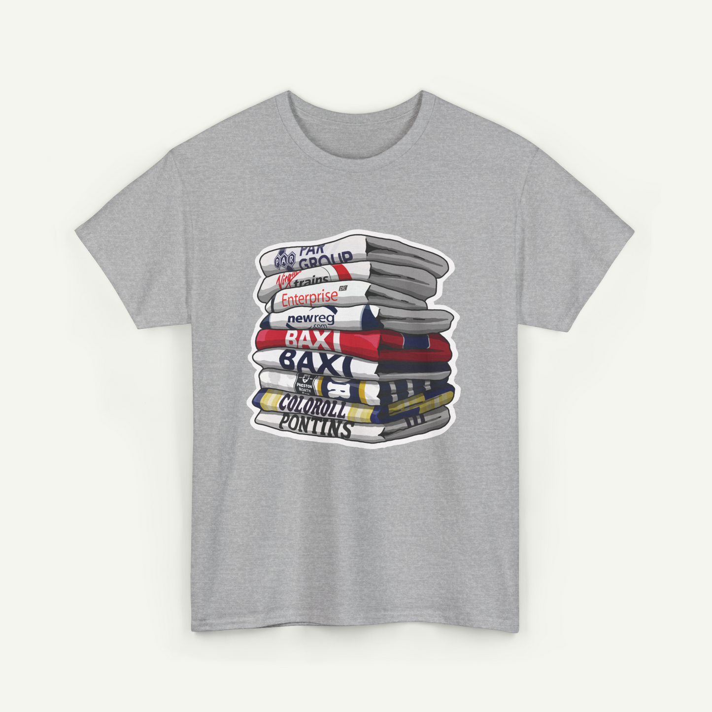 A gray t-shirt with a graphic design depicting a stack of books or magazines with various text labels on the spines.