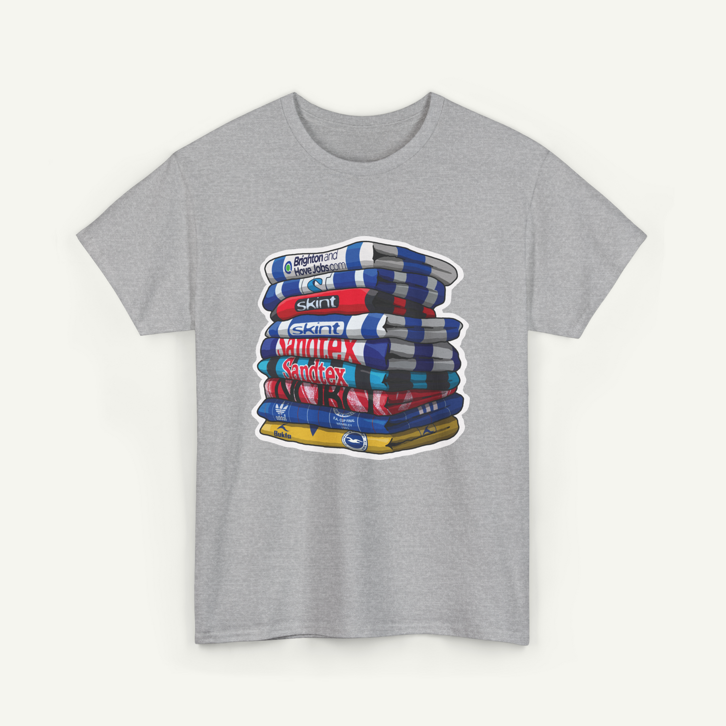 A gray t-shirt with a graphic design depicting a stack of colorful books or magazines.