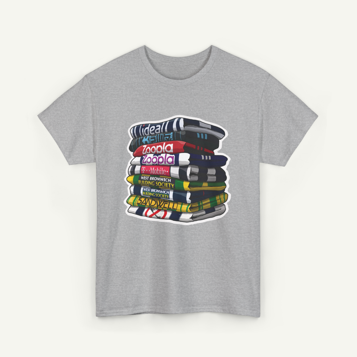 A gray t-shirt with a graphic design depicting a stack of colorful books or magazines.