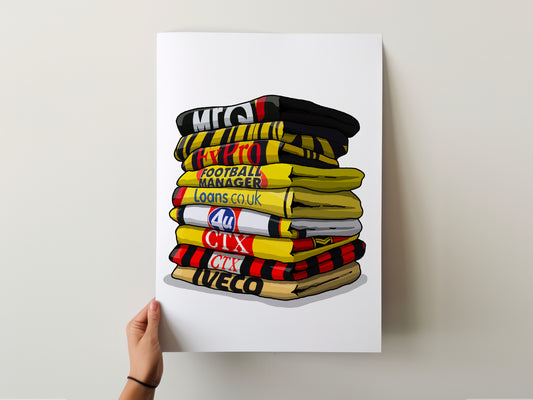 A hand is holding a poster with a stack of colorful football-themed towels or blankets, each with a different text or logo on them.