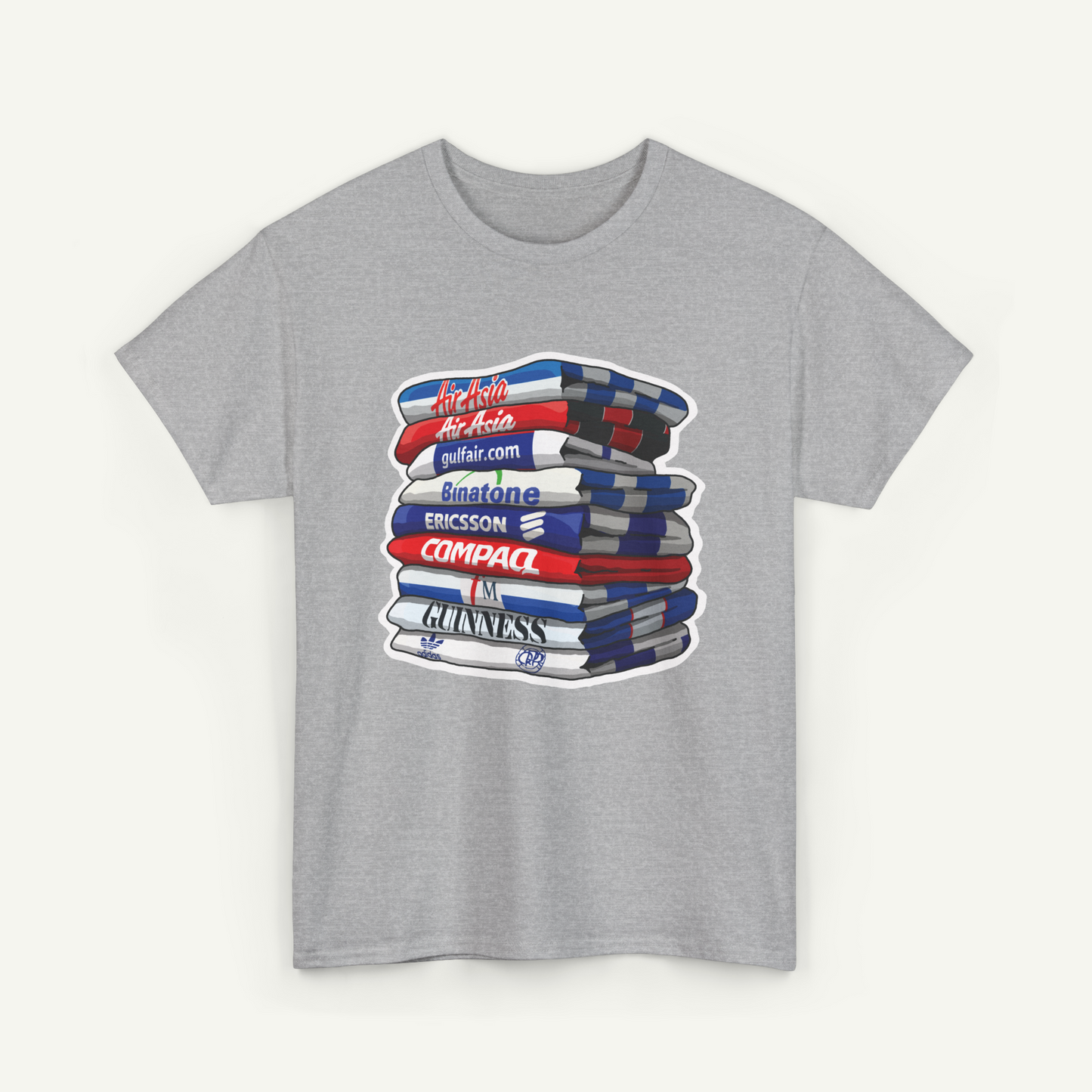 A gray t-shirt with a graphic design depicting a stack of books or magazines with various text elements on them.