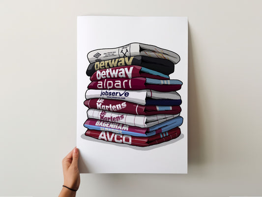 A hand is holding a poster with a stack of colorful towels, each displaying a different word or logo.