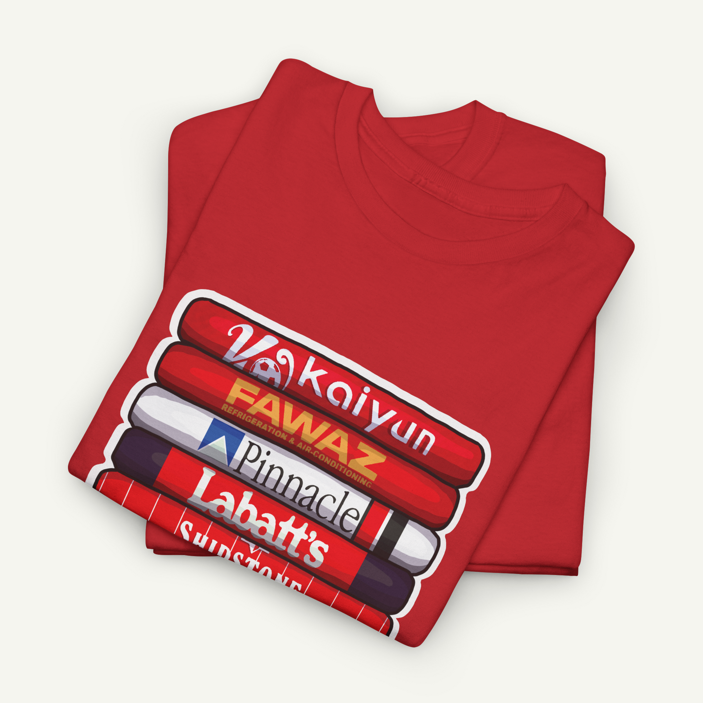 A red t-shirt with a graphic design featuring a stack of books with various text on them.