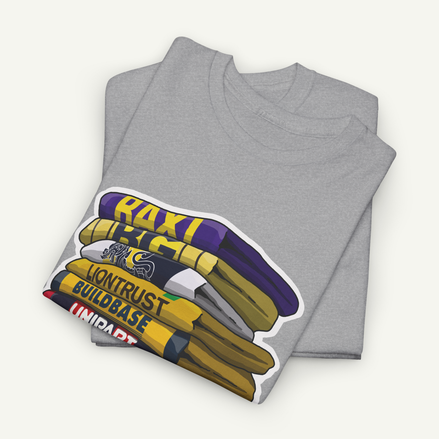 A gray t-shirt with a graphic design depicting a stack of books with the text "RACI" and "LONTRUST BUILDBASE" printed on it.